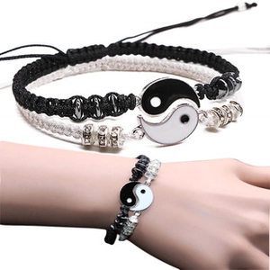 Detail of adjustable Yin Yang Tai Chi braided couple bracelets with metal charms