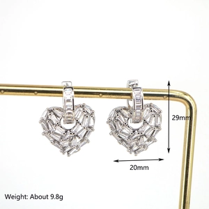 Silver-plated heart hoop earrings with zircon stones, measuring 29mm by 20mm on a stand