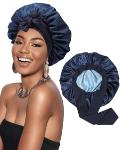 Detail of double-layered navy blue satin sleep cap featuring long ribbons and silky lining