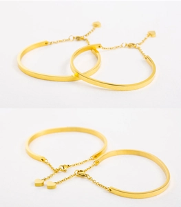 Detailed view of 18K gold plated C-shape bracelet featuring a delicate heart charm