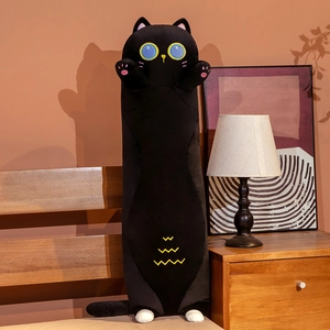 Detail of cute long black cat plush pillow showing yellow eyes and soft velvet texture