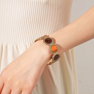 Detail of vintage round leopard print bracelet on wrist with gold metal setting