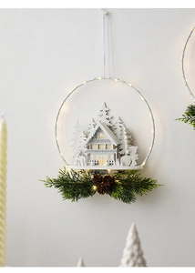 Macro view of Nordic Christmas door hanger with LED white castle, deer and pine cones