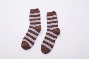 Close-up of brown and white striped coral fleece socks with soft plush texture for men