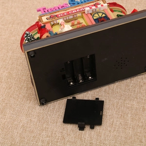 Detailed bottom view showing battery compartment and speaker for the rotating music box