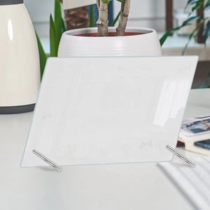 Macro shot of acrylic weekly planner with silver metal stands and cat illustration detail