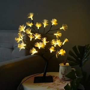 Macro view of fiber optic flower heads and warm LED lights on a black birch tree lamp