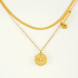 Detail of gold double-layered necklace with snake chain and star coin pendant