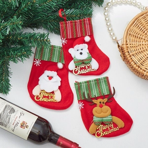Three 3D cartoon Christmas stockings with Santa, reindeer, and bear designs on a festive setup