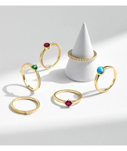 Macro detail of S925 sterling silver rings featuring opal and zircon in gold finish