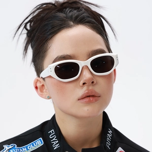 Close-up of white cat-eye polarized sunglasses on model with retro aesthetic design