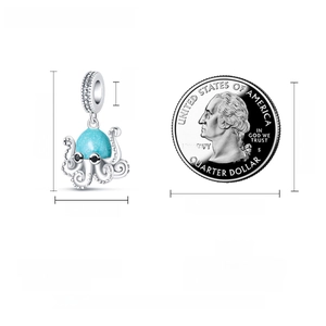 Detailed size comparison of glow-in-the-dark silver octopus charm with coin reference