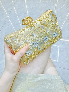 Luxury gold evening clutch with floral crystal inlay and detachable chain strap