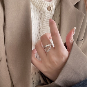 Minimalist 925 sterling silver chain drop ring on a model with neutral background