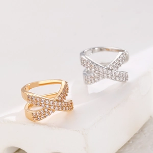 Detailed close-up of double-layer X-cross ear cuff with shimmering cubic zirconia