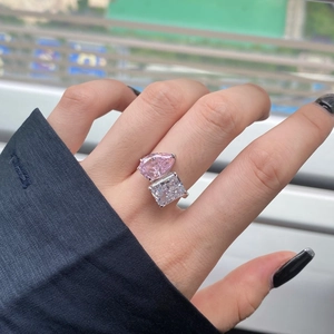 Macro view of Toi et Moi silver ring with pink pear and clear square cut stones