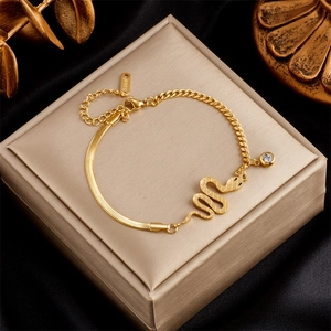 Gold-plated stainless steel jewelry set with a snake pendant and crystal on a box
