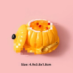 Top view of miniature resin pumpkin bowl with golden spoon, size 4.9x3.8x1.8cm