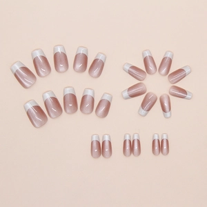 Macro view of 24pcs pink cat-eye press-on nails with white French tips and glitter