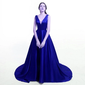 Detail of royal blue satin evening gown featuring a deep V-neck and elegant flared skirt