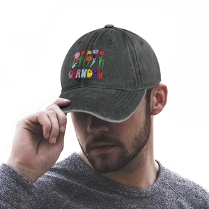 Close-up of colorful floral embroidery and GRANDMA text on washed gray cotton baseball cap