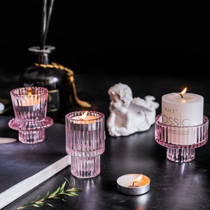 Pink ribbed glass candle holders in three elegant shapes for luxury home dining decor