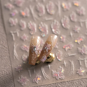 Macro shot of iridescent butterfly nail stickers and nude gradient luxury press-on nails