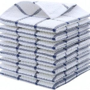 Cotton blue checkered waffle weave kitchen towels neatly stacked on white background