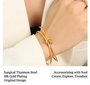 Detail of 18k gold plated surgical titanium steel knotted bracelet on wrist