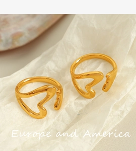 Close-up of adjustable 18k gold plated open rings with minimalist hollow heart designs