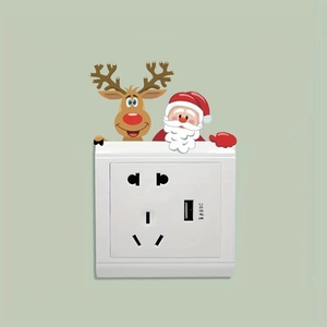 Detail of Christmas Santa and reindeer wall stickers around a dual AC socket with USB port
