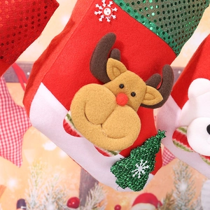 Detail of Christmas stocking with 3D reindeer plush and sequined tree decoration
