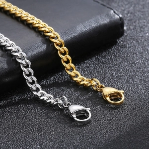 Macro detail of gold and silver cuban link bracelets with secure lobster clasps