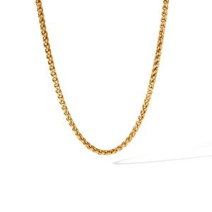 Close-up of golden wheat chain necklace featuring detailed woven V-shaped links