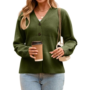 Detail of dark green knit cardigan featuring elegant vertical ribbed texture and brown buttons