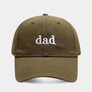 Detailed view of white 'dad' embroidery on olive green cotton twill baseball cap