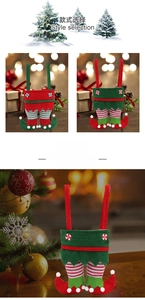 Detailed view of red and green Christmas elf leg candy bags with festive bells and stripes