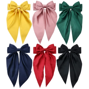 Detail view showing six colorful satin bow hair clips in a grid on a white background