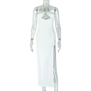 Detail of white bodycon maxi dress featuring a high side slit and chest cutout