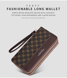 Detail of vintage long wallet with double zippers and classic pattern on brown leather texture