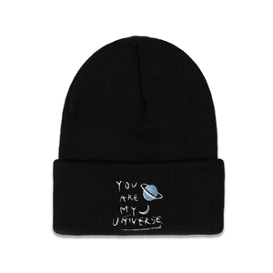 Close-up of black beanie with planet embroidery and 'YOU ARE MY UNIVERSE' text detail