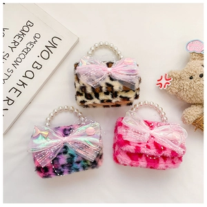 Detailed view of three plush leopard print mini bags with pearl handles and bow accents