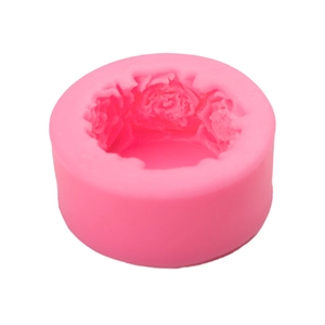 Pink cylindrical silicone mold with detailed rose pattern for DIY baking and soap making