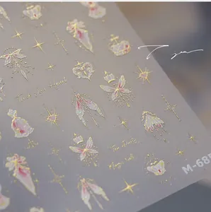 Macro detail of M-685 nail stickers featuring gold foil butterflies and stars
