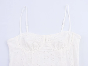 Detail of white Broderie Anglaise corset top with embroidery and adjustable straps
