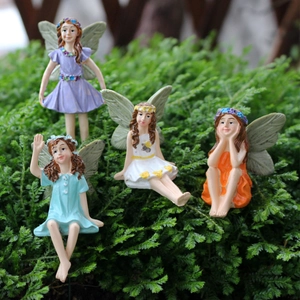 Group of four resin flower fairy figurines in various poses for garden decor