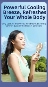 Close-up of a portable handheld fan used by a woman in a sunny outdoor park setting.