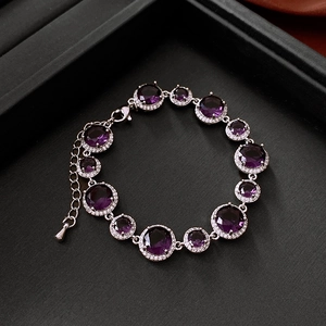 Close-up of vintage gold plated bracelet with purple zircon and halo diamond setting