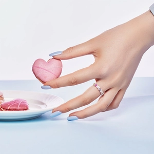 Close-up of S925 sterling silver ring with colorful zircons on a model's finger
