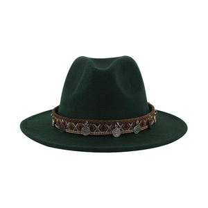 Detail of dark green felt fedora featuring ethnic woven band and retro metal charms
